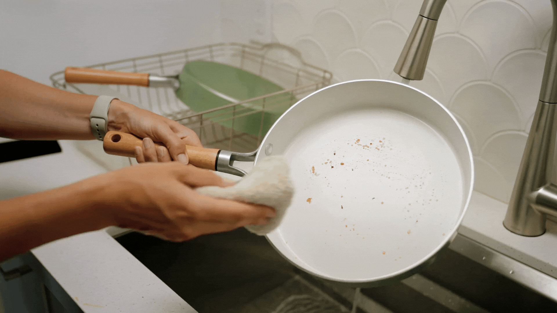 How to Clean Ceramic Cookware Gif of easily cleaning a Cardamom Nonstick Frying Pan with a rag in the sink.