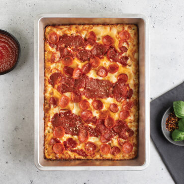 Classic detroit style pizza with pepperoni and sauce made in Nordic Ware's Detroit Style Pizza Pan