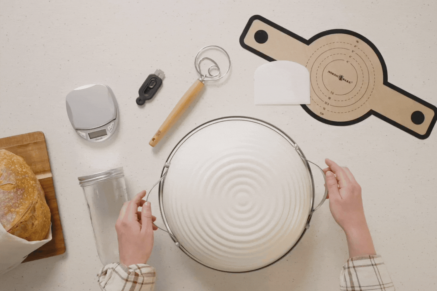 Overhead video of the Deluxe Simply Sourdough Bread Baking Kit. Hands removing the lid of the Simply Sourdough Bread Baking Pan.