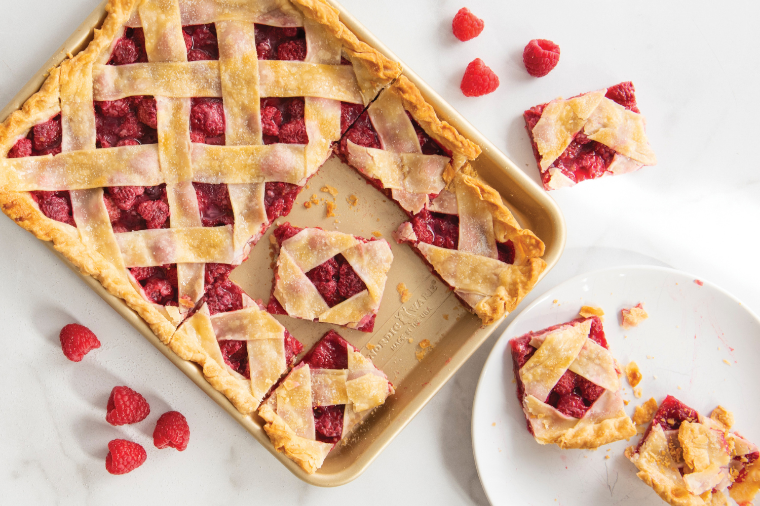 Naturals® Nonstick Baker's Quarter Sheet Pan with raspberry pie bars in it.