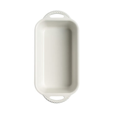 overhead view of cardamom loaf pan on white background showing white nonstick interior