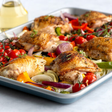 brilliant half sheet with chicken and veggies in pan