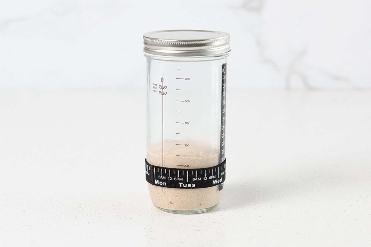 Sourdough starter jar full of sourdough starter that has doubled.