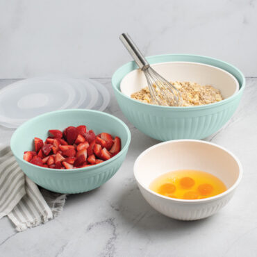 Nordic Ware 8 piece seaglass and white 7 quart, 5 quart, 3.5 quart and 2 quart bowls filled with dough, strawberries, and egg yolks