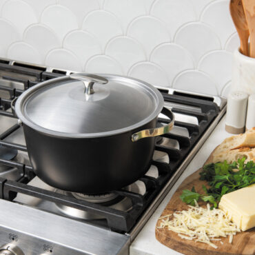 nordic ware 6 qt aluminum dutch oven and lid with stainless steel handles and stainless steel lid and knob on stovetop