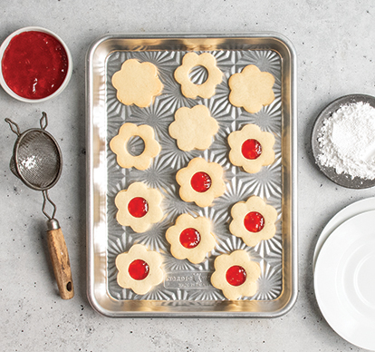 Image of baked flower sugar cookies on Nordic Ware's Vintage Starburst Quarter Baking Sheet