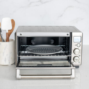 nordic ware compact perforated hot air pizza crisper staged in toaster oven