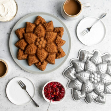 nordic ware cast aluminum poinsettia pull apart pan and plated cake on countertop with silverware and warm beverages