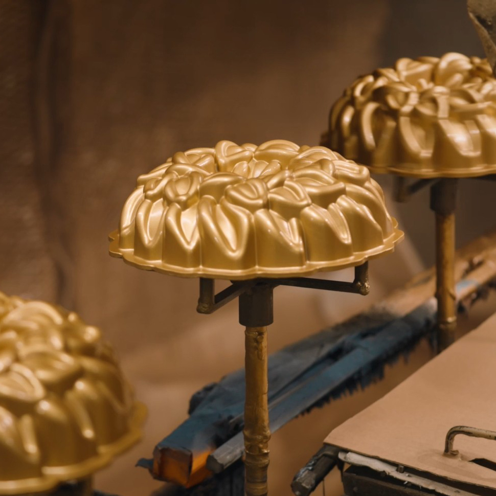Image of Laurel Bundt Pans on a coatings line in Nordic Ware Factory