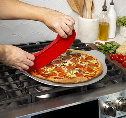 Image of man cutting pizza with Nordic Ware Rock the Boat Pizza Cutter on pepperoni pizza baked on Nordic Ware Pizza Steel 